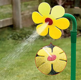 Decorative sunflower garden sprinkler head spraying water evenly, plastic adjustable tool perfect for lawns.