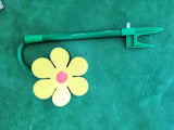 Eye-catching plastic sunflower sprinkler for gardens, adjustable rotating tool for full lawn water coverage.