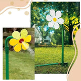 Funny spinning sunflower sprinkler spraying water on backyard lawn, adjustable garden irrigation plastic sprinkler tool.