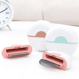 Pet grooming tool with pink and white design on a light background